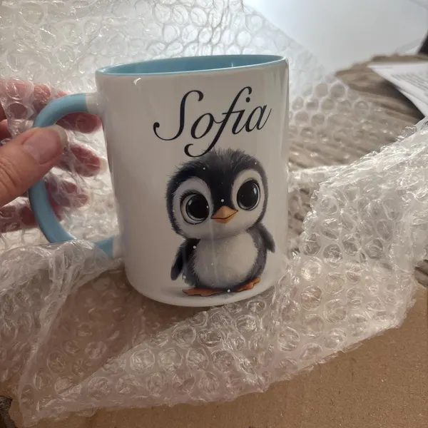 Customer photo of a personalised penguin mug from TheMugVault